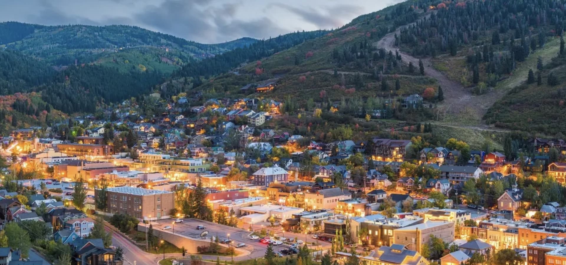 Old Town Park City lit up at dusk beneath the Wasatch